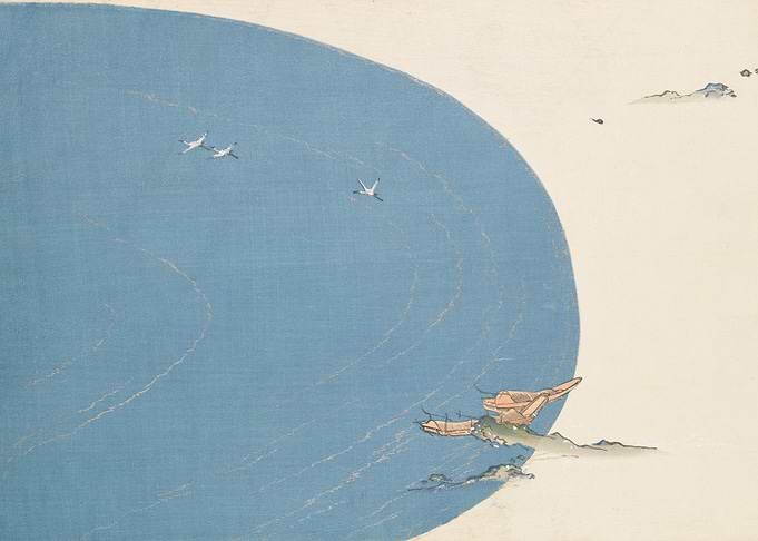 Cranes flying over boats near shore