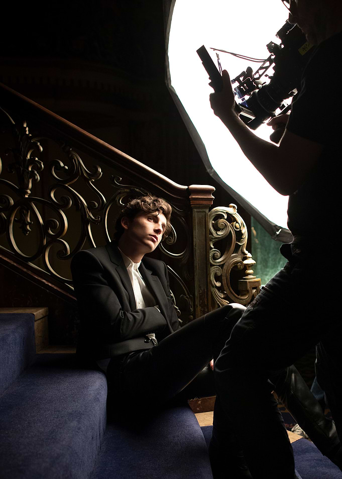 Man on stairs with camera crew