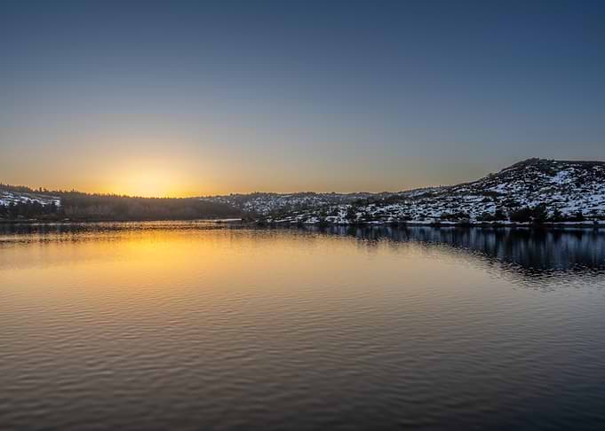 Sunrise over a snow-dusted lake