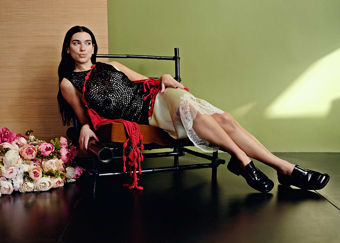 Woman in black top and slip dress posing