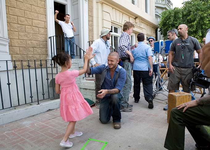 David Beckham and a young girl high-fiving