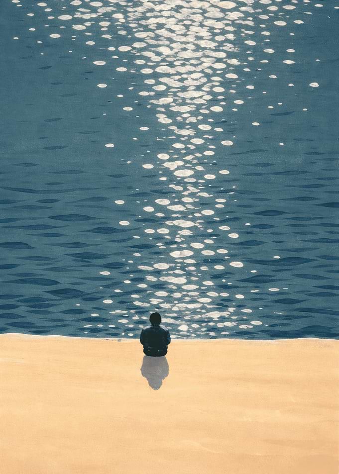 Person sitting by the sea