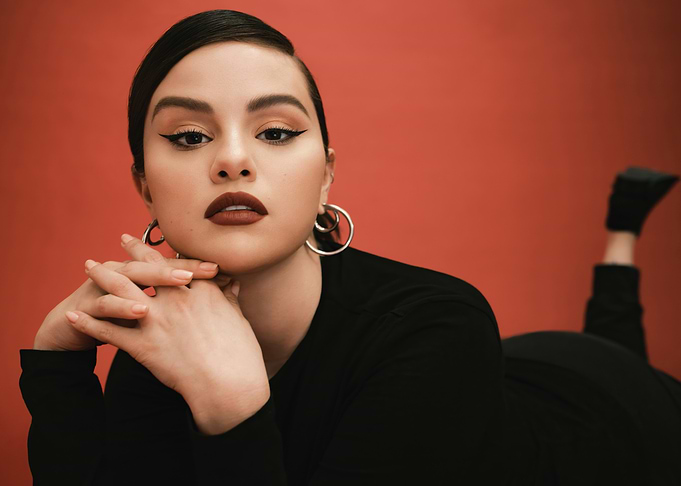 Selena Gomez Posing Against Red Background