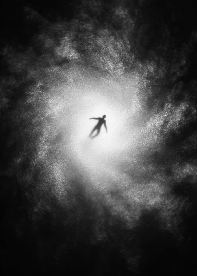Silhouette of a person falling into a vortex