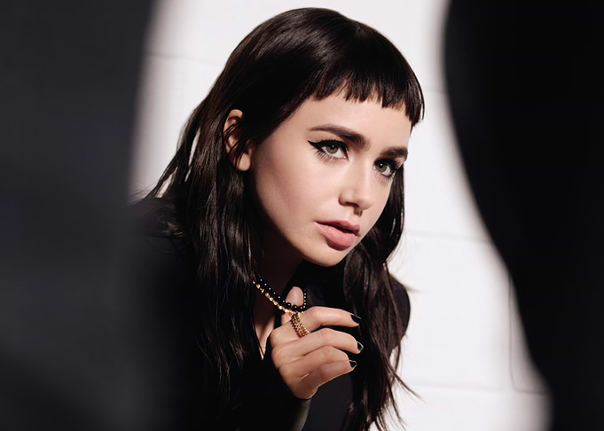 lily collins with dark hair and bold makeup