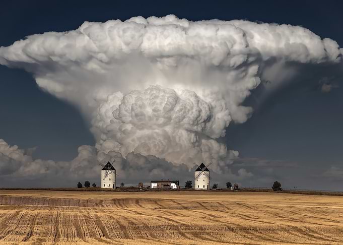 Dramatic storm clouds over windmills