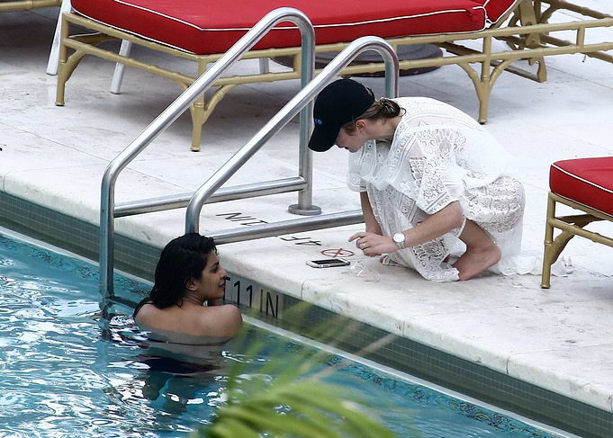 Two women by a swimming pool