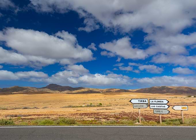 Roadside signs in a desert landscape, Fuerteventura