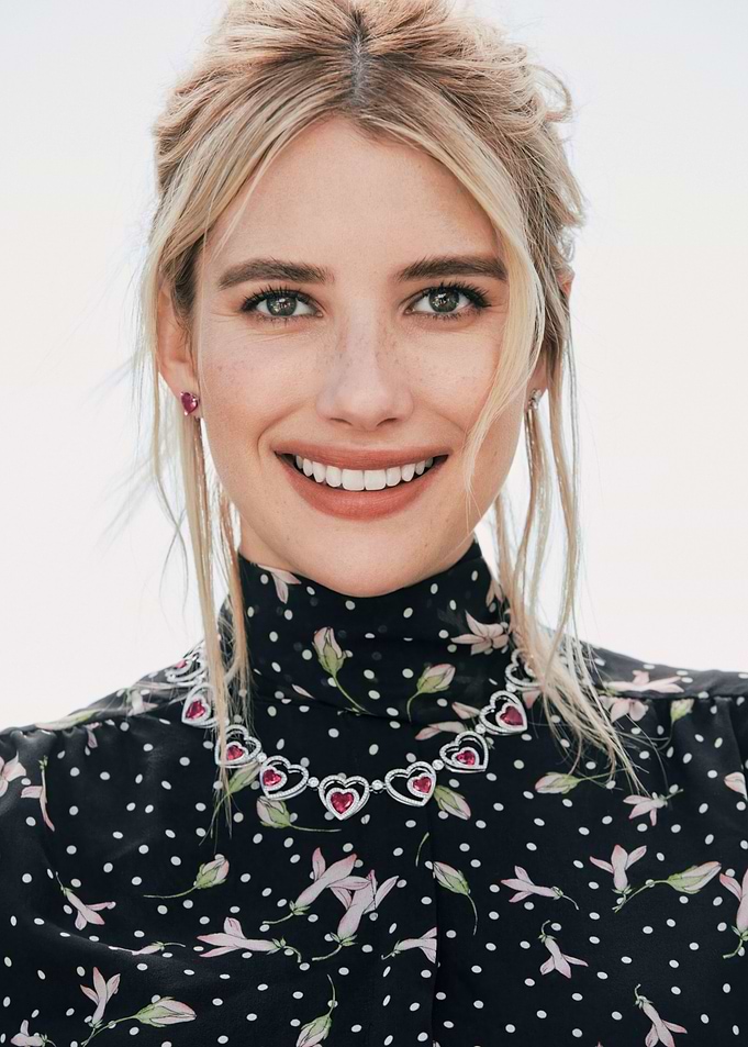 Emma Roberts smiling with heart necklace
