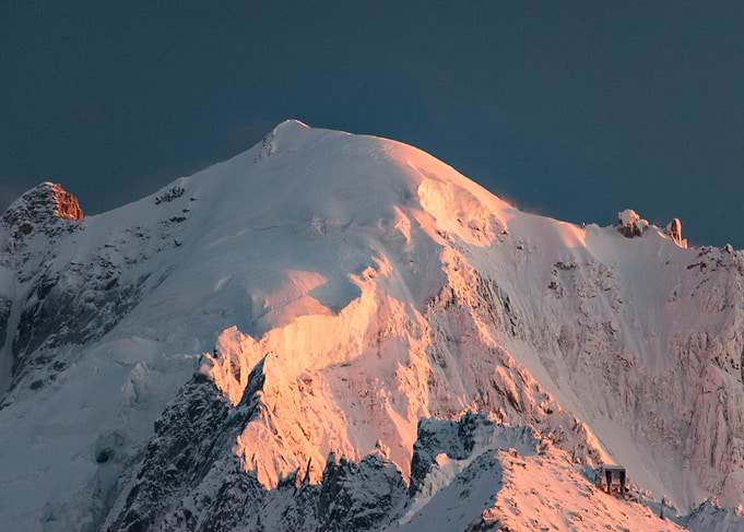 Snow-capped mountain peak at sunrise