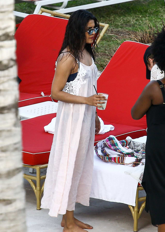 Priyanka Chopra in a sheer dress holding a drink