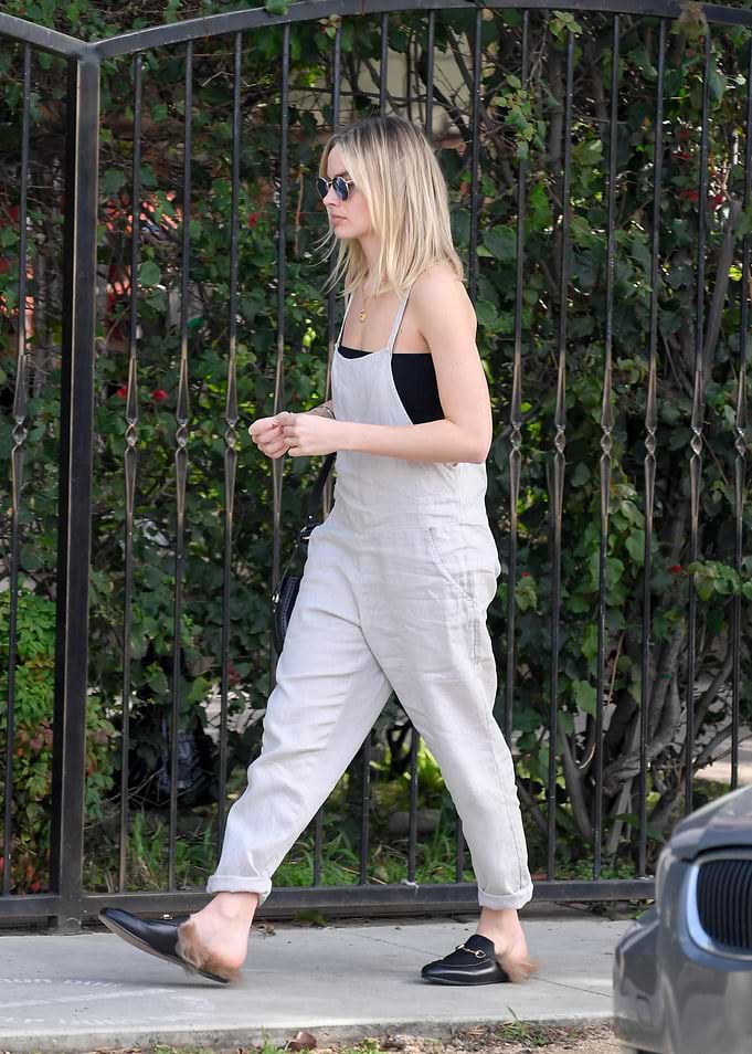 Woman in Overalls Walking Outdoors