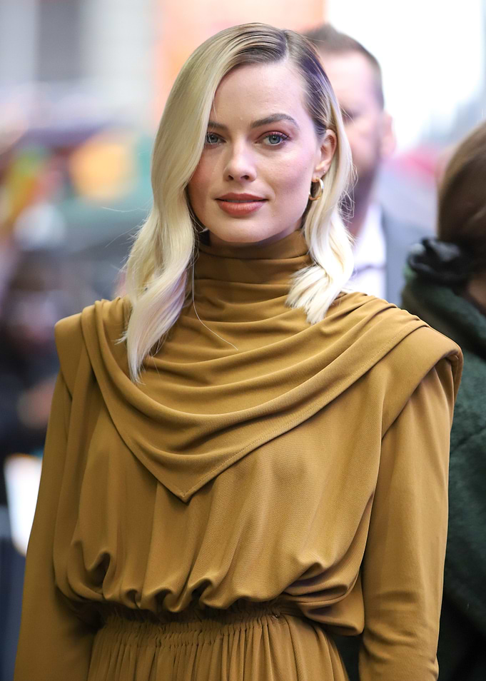 Margot Robbie in a stylish brown dress