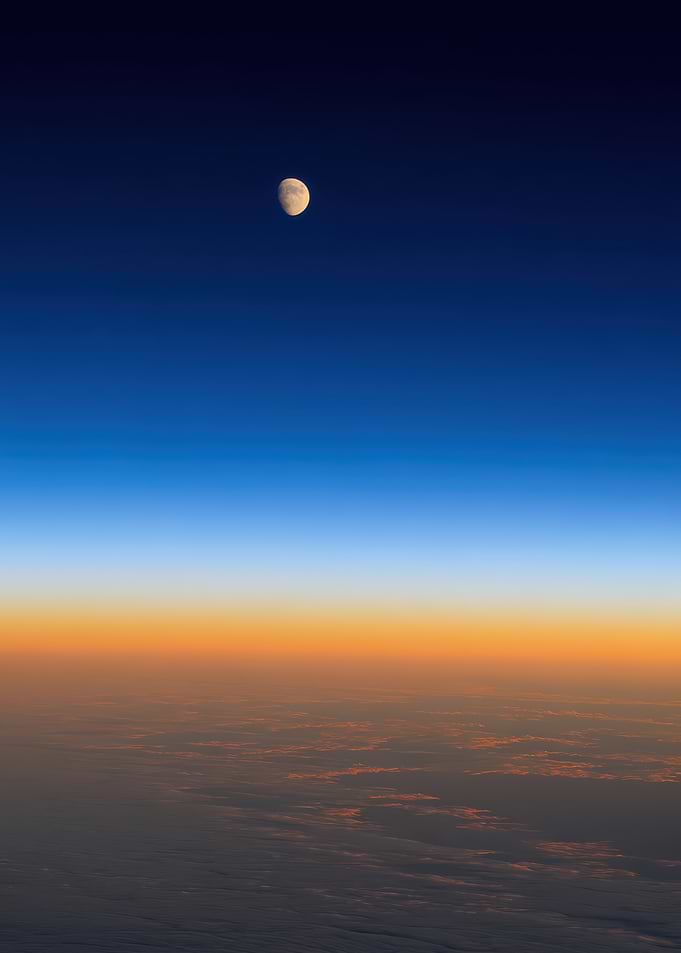 Moon over clouds at sunset