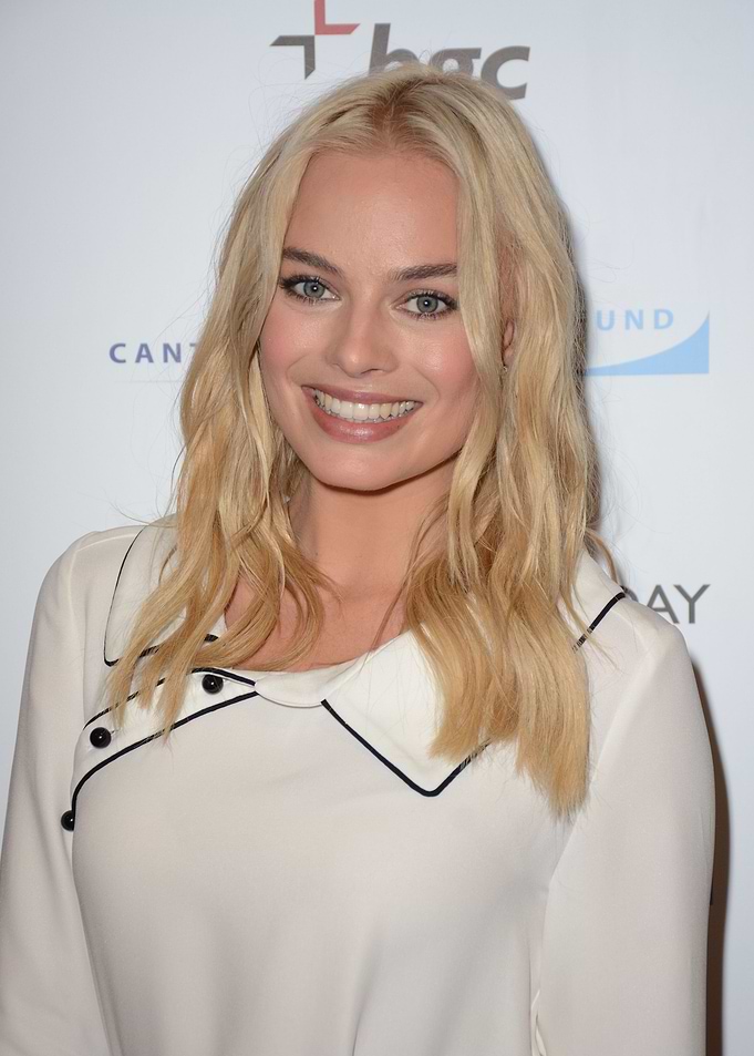 Margot Robbie smiling at event