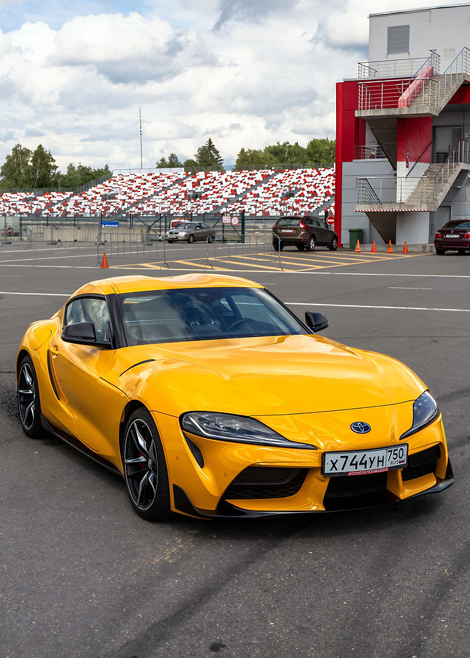 Yellow Toyota Supra on a Race Track