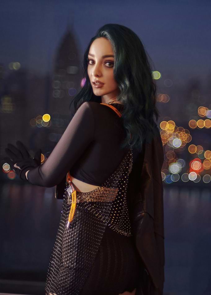Emma Dumont with green hair in black outfit
