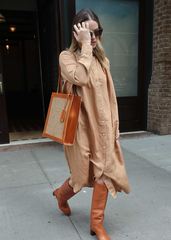 Woman in tan dress and boots