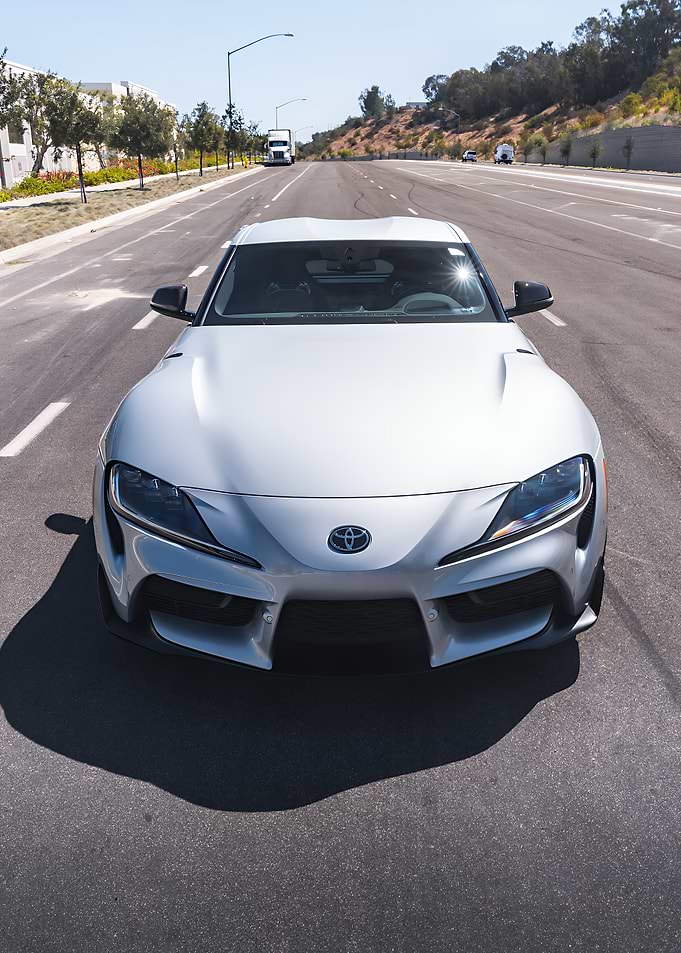 Silver Toyota Supra on a Sunny Road