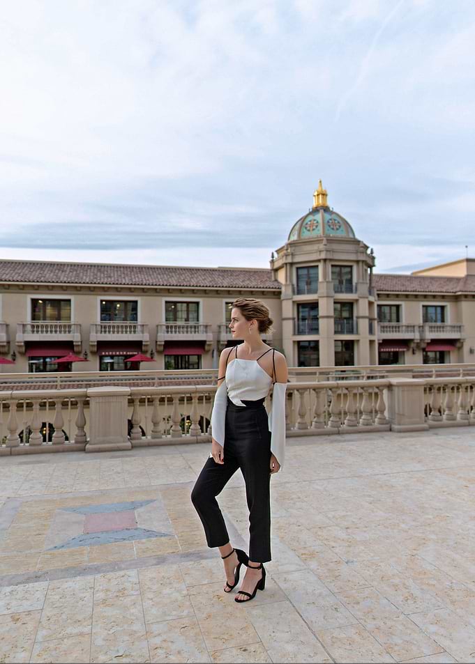 Woman in stylish outfit posing outdoors