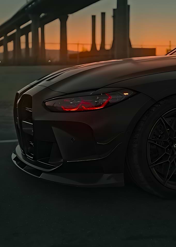 Dark BMW M4 Headlight at Sunset