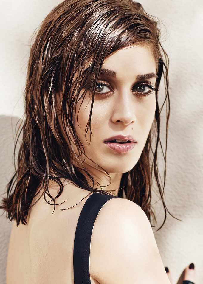 Lizzy Caplan with wet hair looking over shoulder