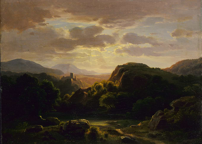 Castle ruins at sunset in a valley