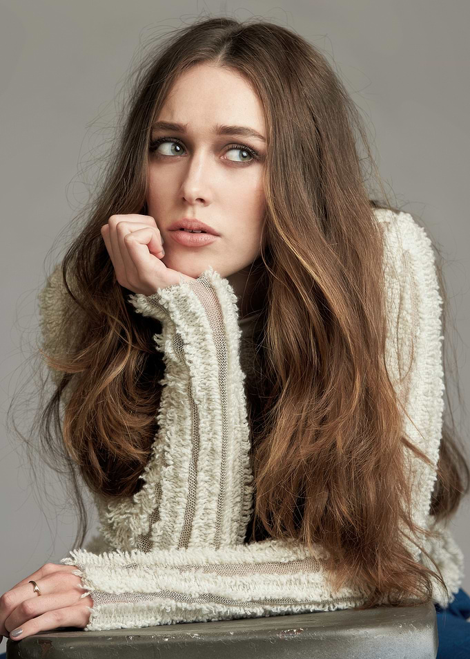 Alycia Debnam with long brown hair in a textured sweater