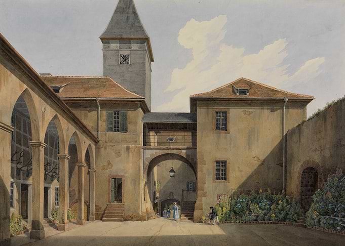 Courtyard of a historic building with a tower