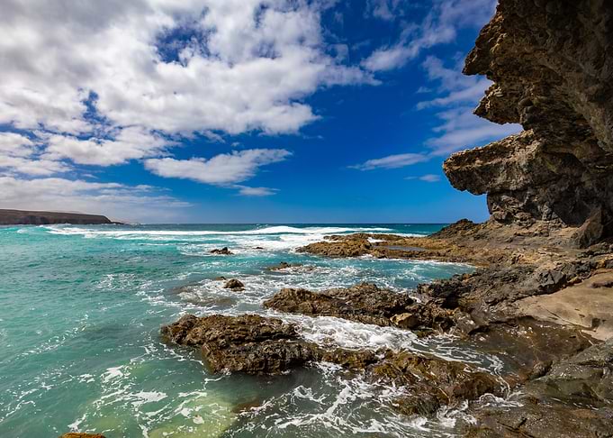 Rocky Coastline with Turquoise Ocean and Blue Sky