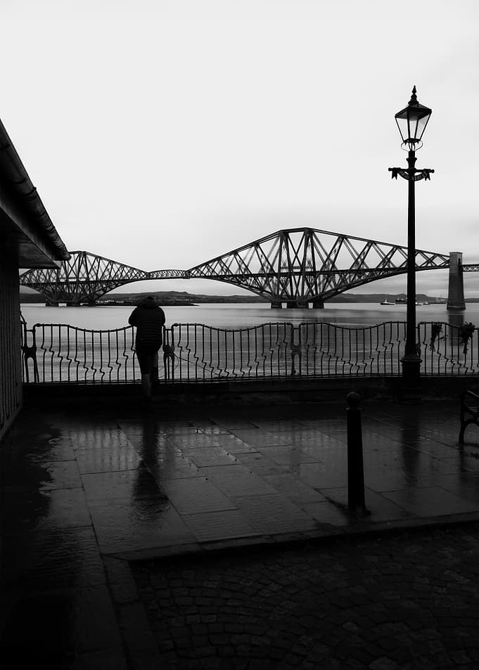 Person overlooking Forth Bridge