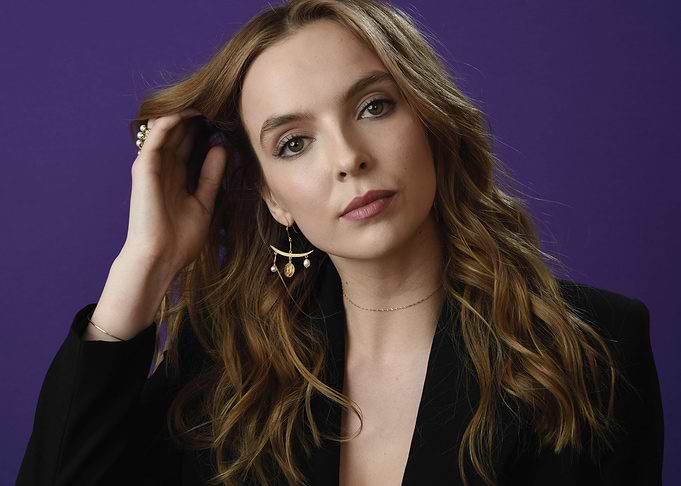 Jodie Comer Poses Against Purple Background