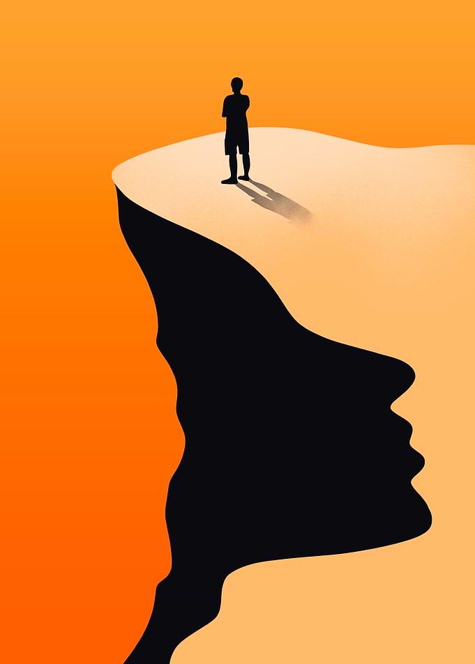 Man on cliff edge with face shadow