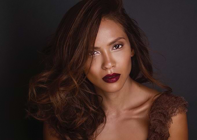 Lesley-Ann Brandt with dark lipstick and wavy hair