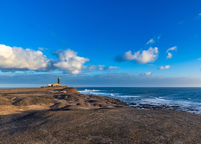 Lighthouse on a rocky coast at sunset, Canary Islands
