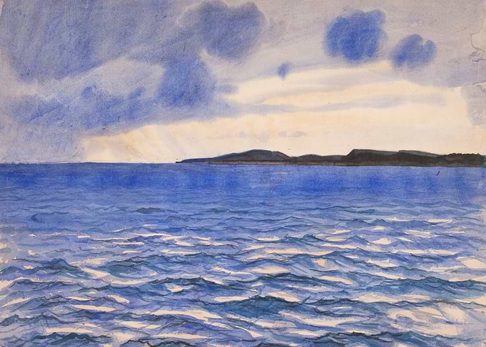 Ocean and Coastline Under Cloudy Sky