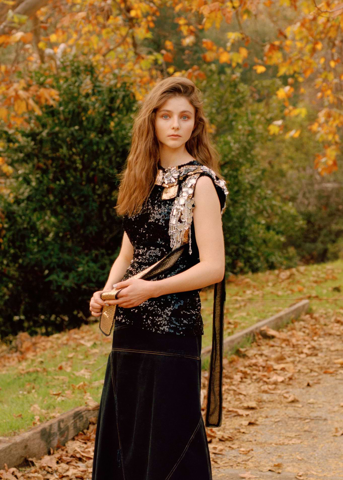 Thomasin McKenzie in sequined dress in autumn park