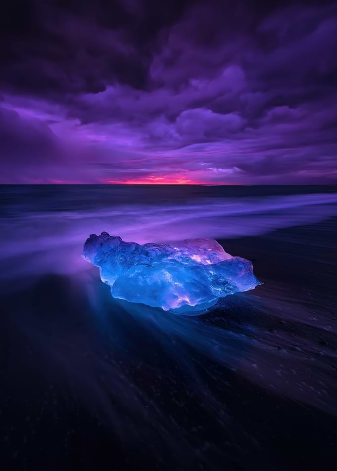 Iceberg on a Black Sand Beach at Sunset