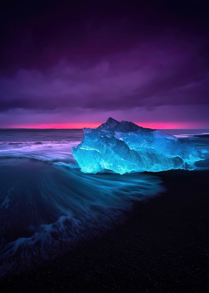 Glowing Iceberg on Black Sand Beach