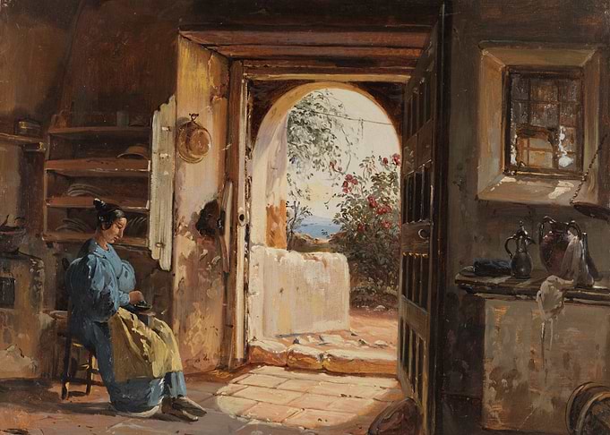 Woman working in a sunlit room with a view