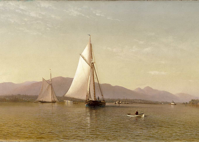 Sailboats on a calm lake with mountains