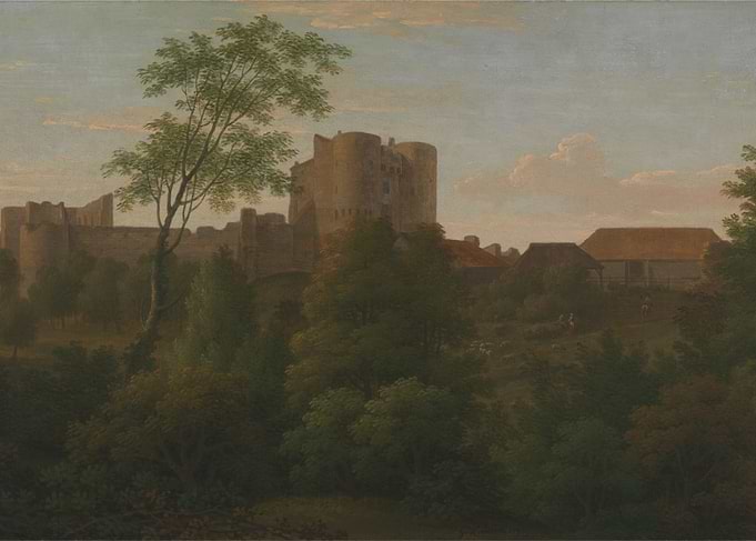 Castle ruins with trees and farm buildings