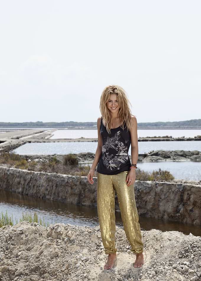 Woman in gold pants by salt flats