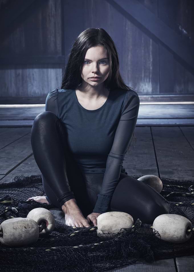 Woman in dark clothing on fishing net