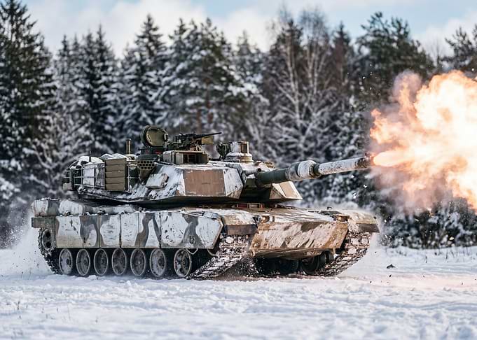Tank firing in a snowy forest