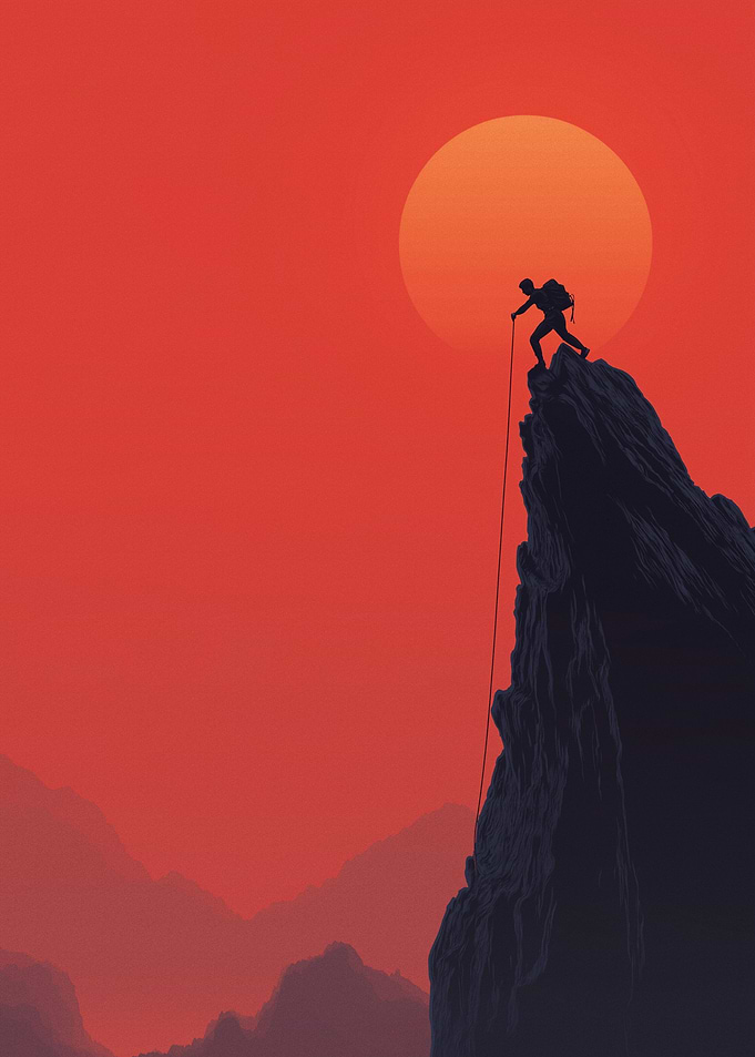 Climber on a mountain at sunset