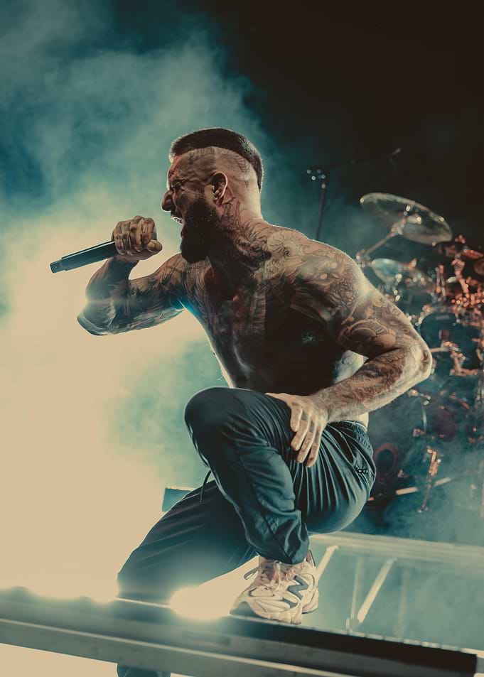 Tattooed Musician Performing on Stage