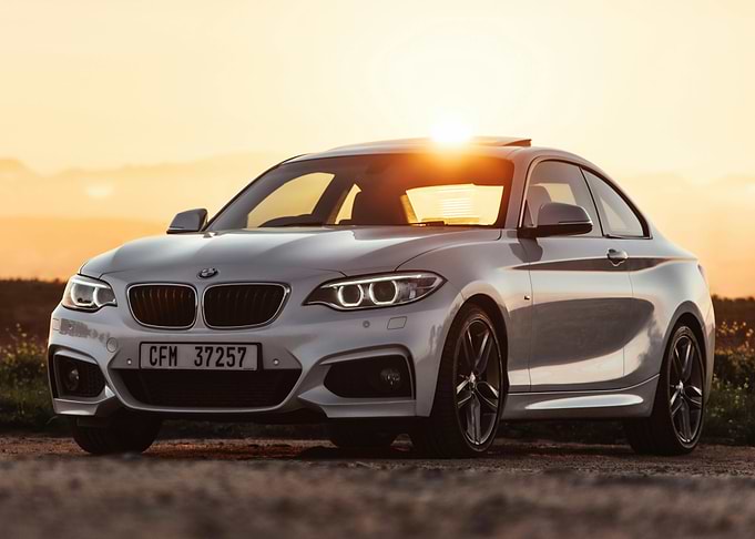Silver BMW Coupe at Sunset