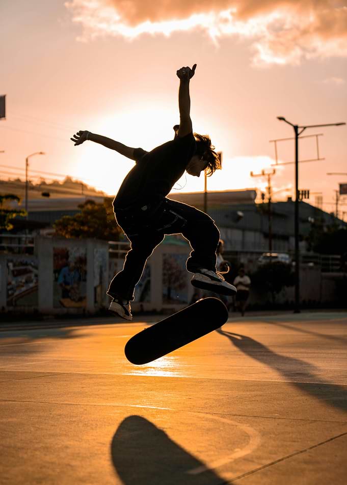 Skateboarder performing a trick at sunset