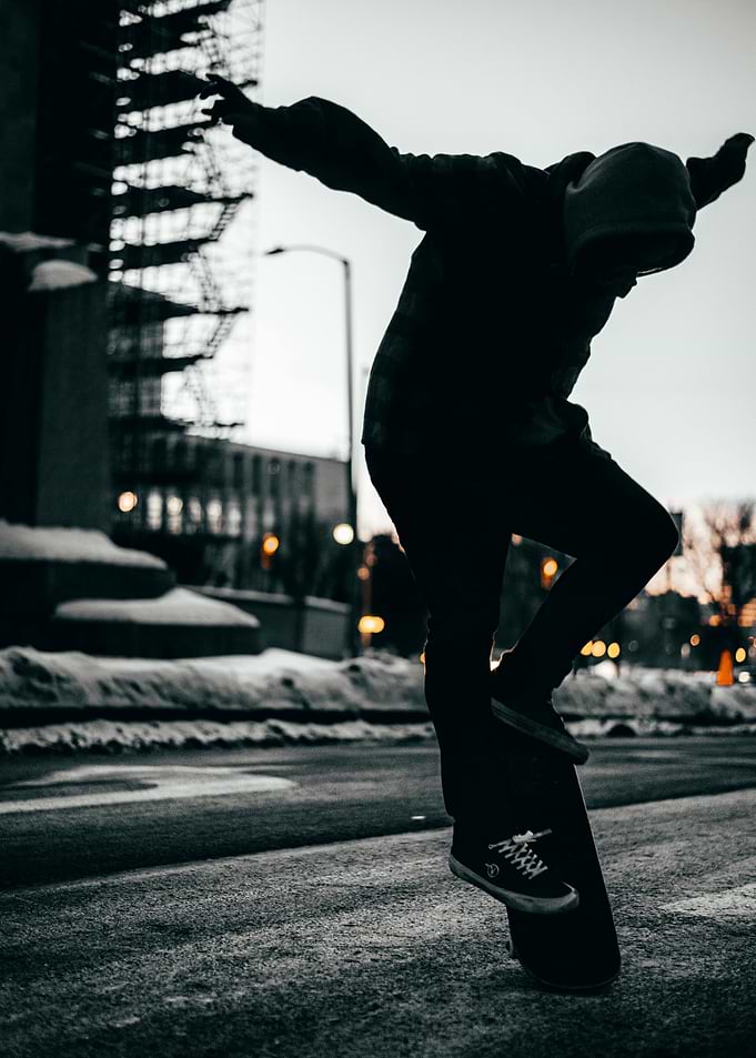 Skateboarder performing a trick at dusk